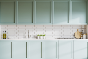 a kitchen with green handleless cabinets