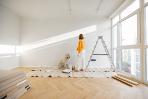 a woman and her dog next to a ladder