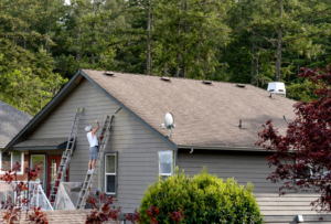 a person painting their home’s exterior